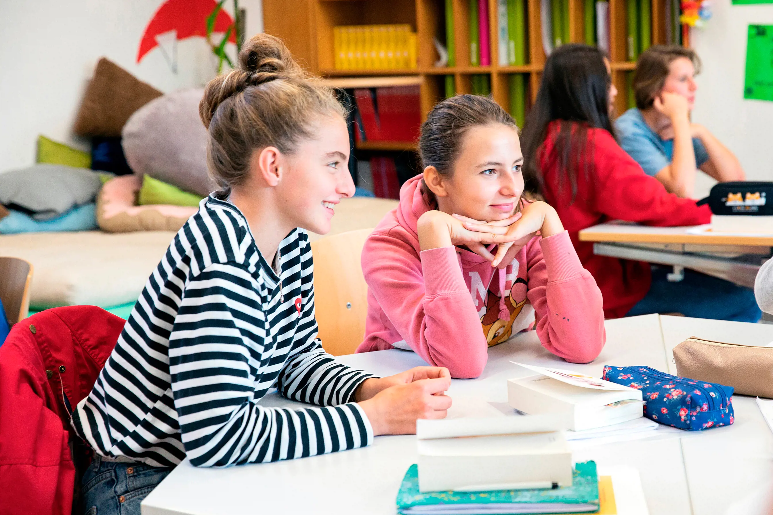 Two students listen attentively.