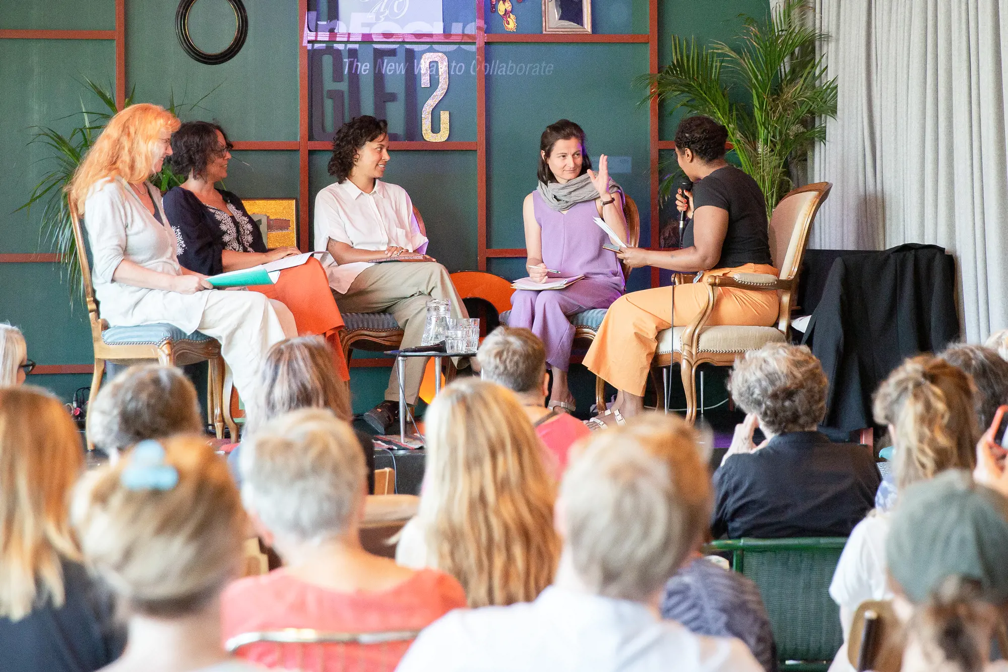 Five participants exchange views in a panel discussion.