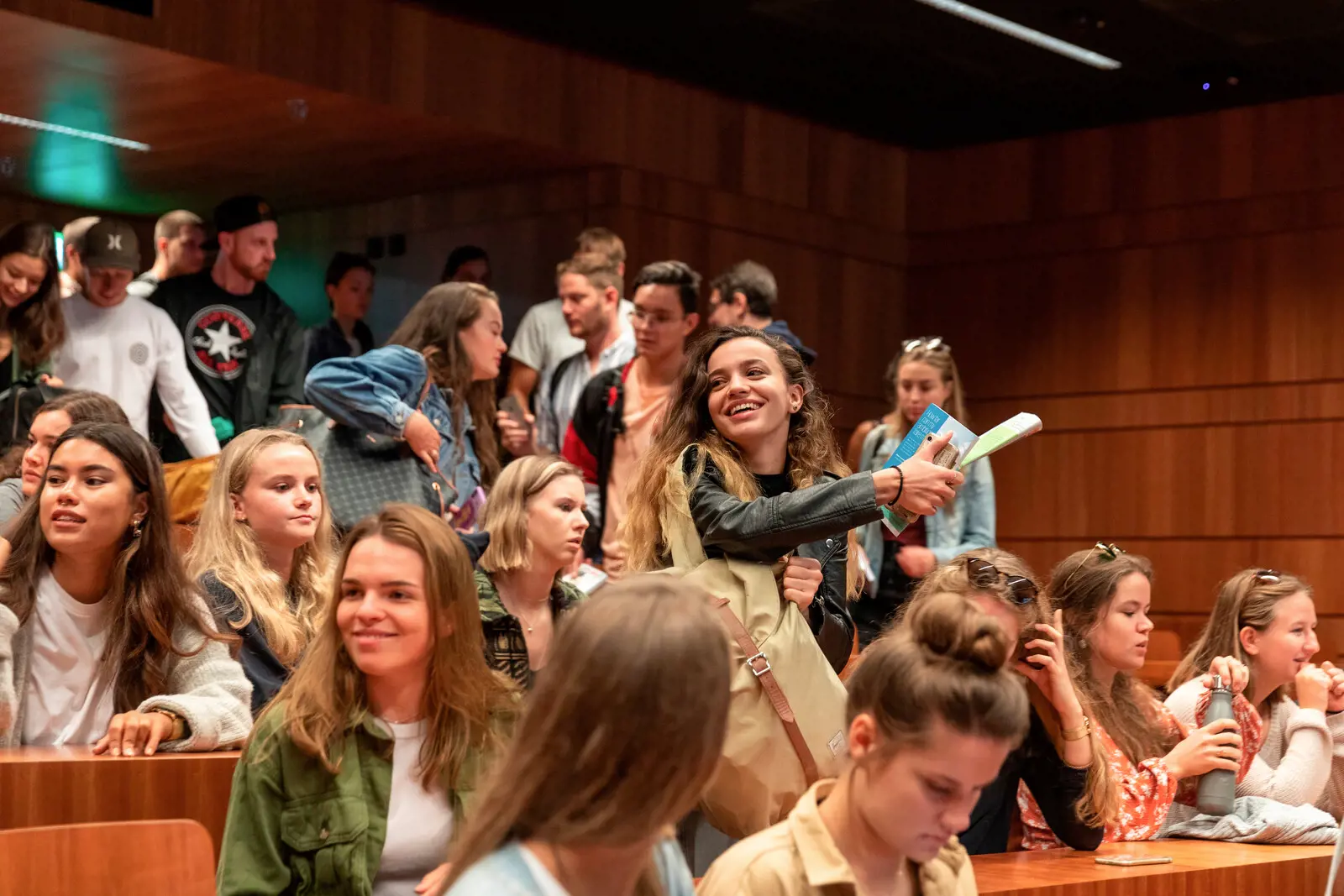 Studierende sprechen miteinander nach einer Vorlesung im grossen Hörsaal.