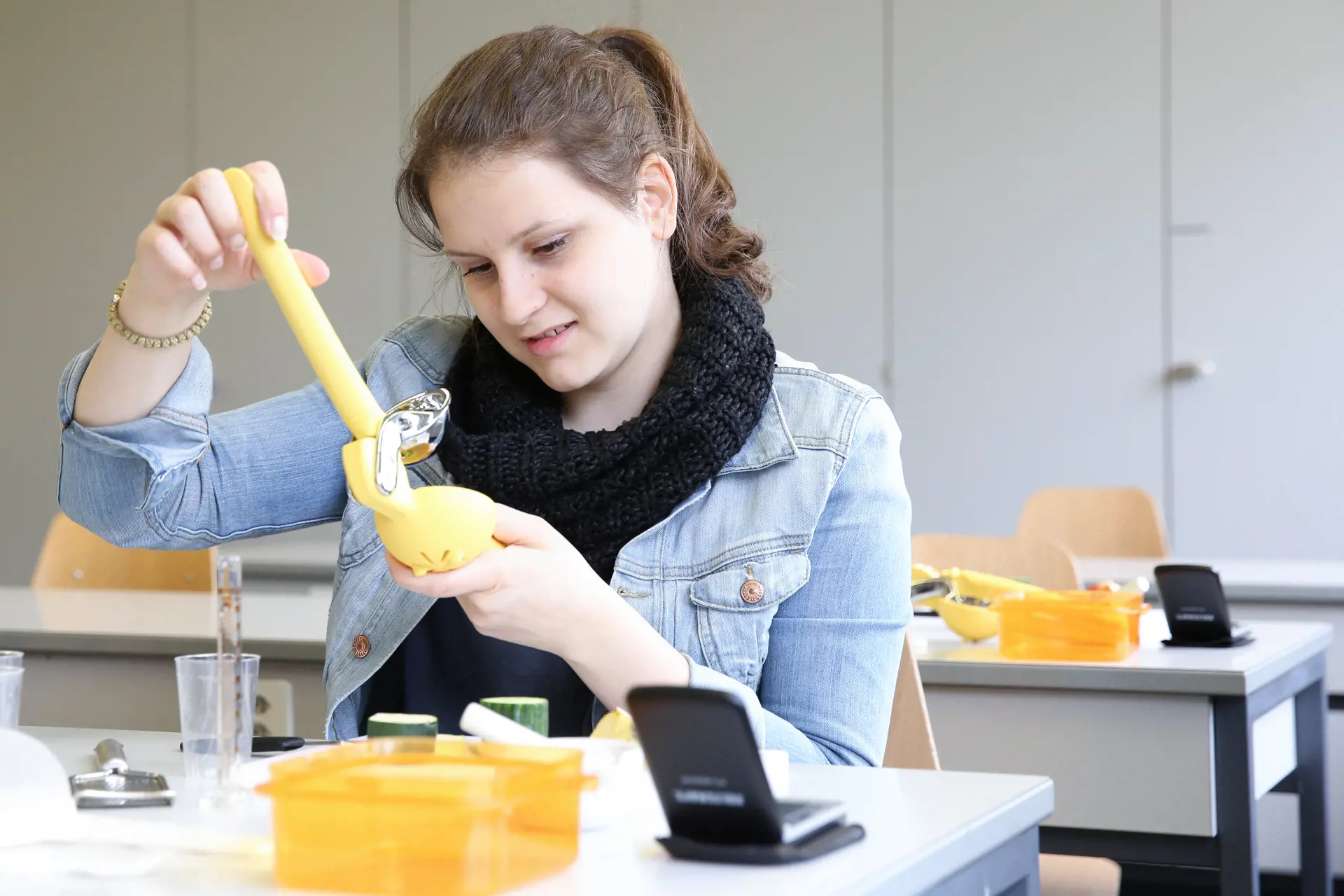 A student is sitting at her workstation conducting a science experiment.