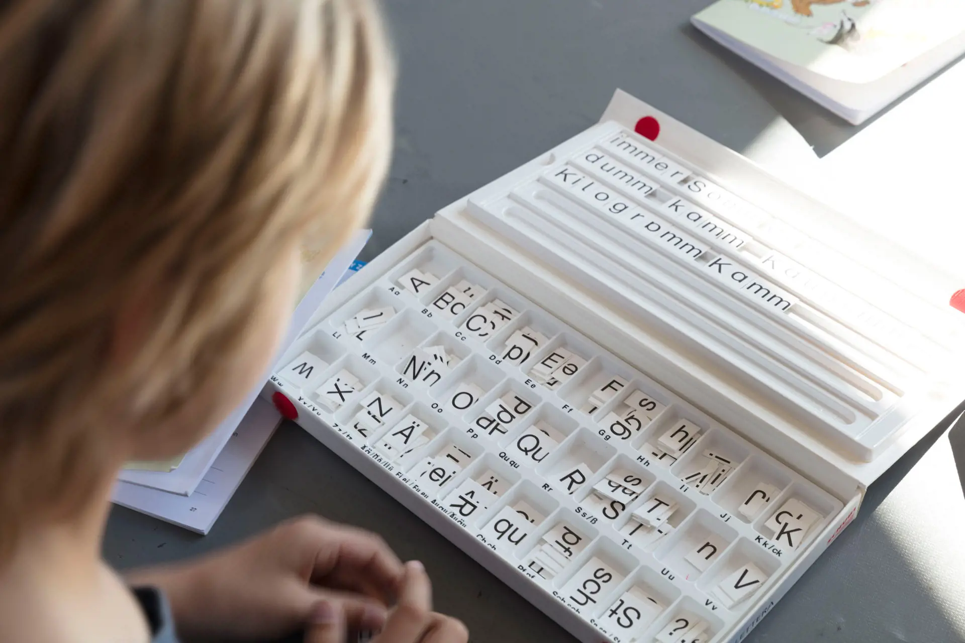A person writes some words in a kind of writing box